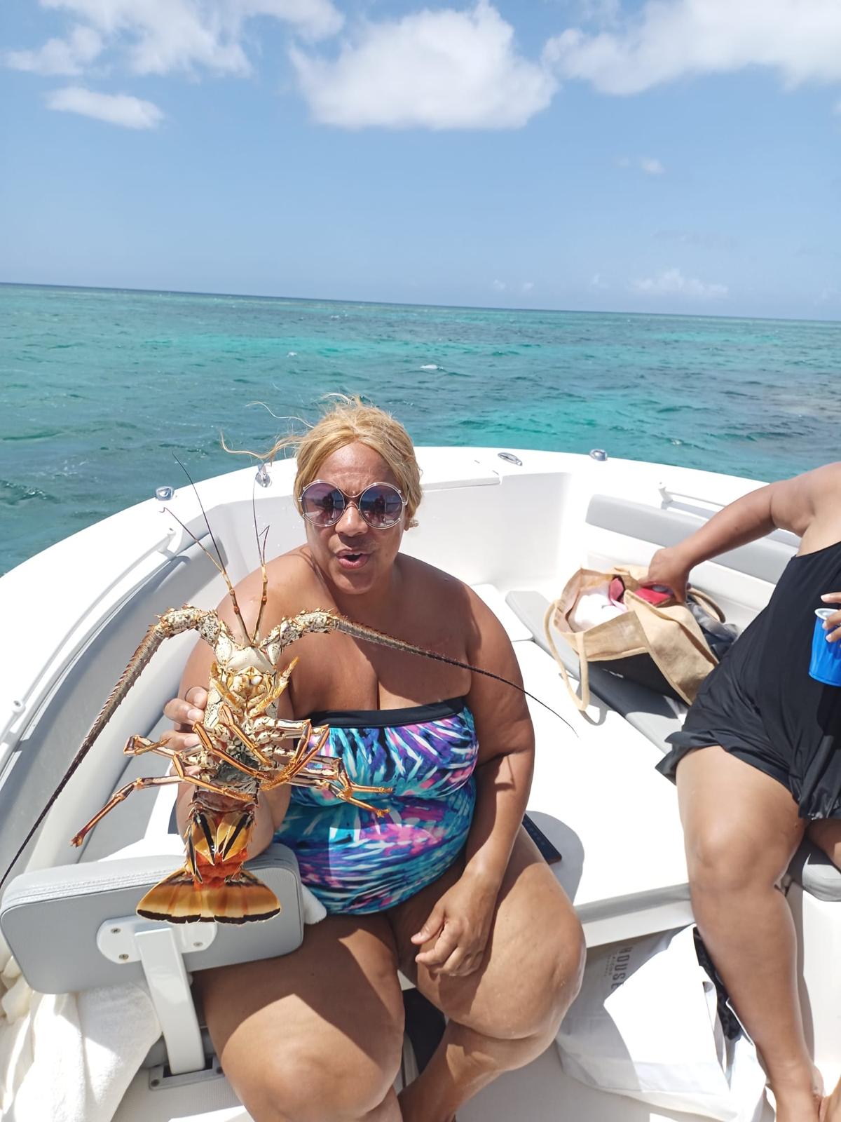 Guest posing with a spiny lobster