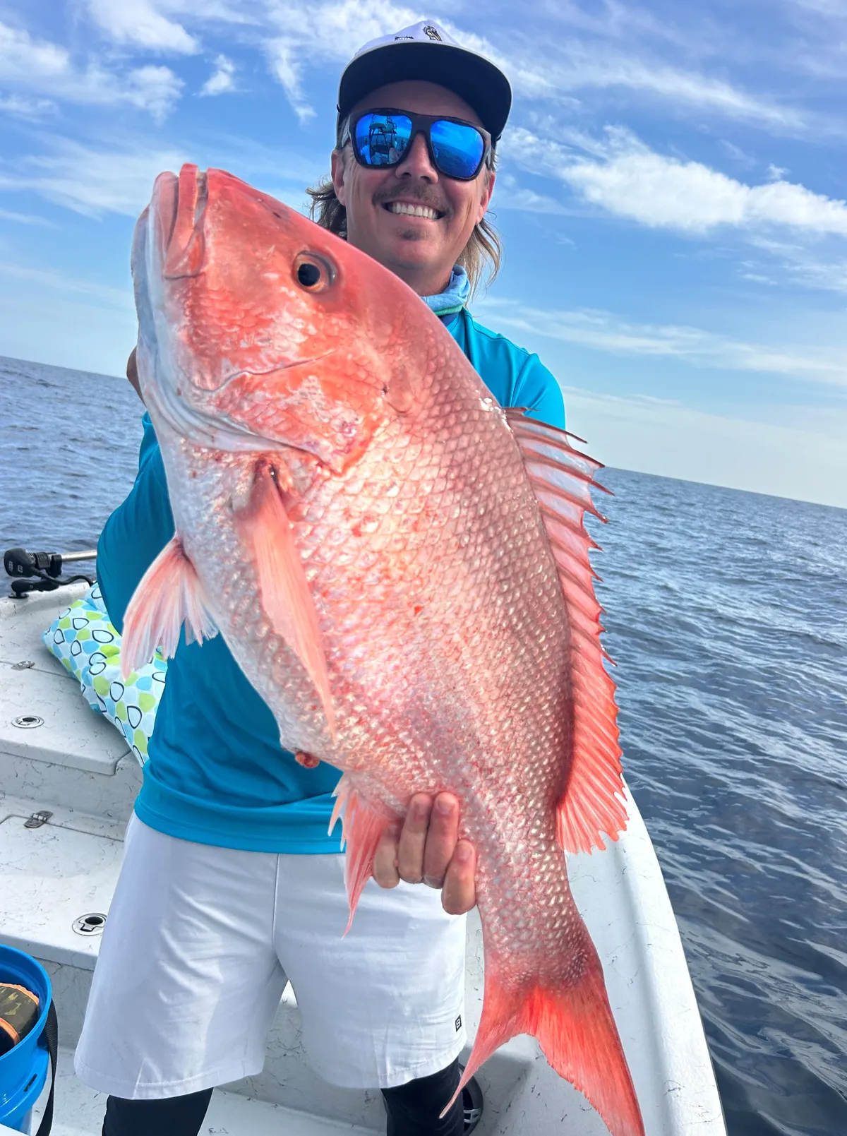 Captain holding a freshly caught red snapper