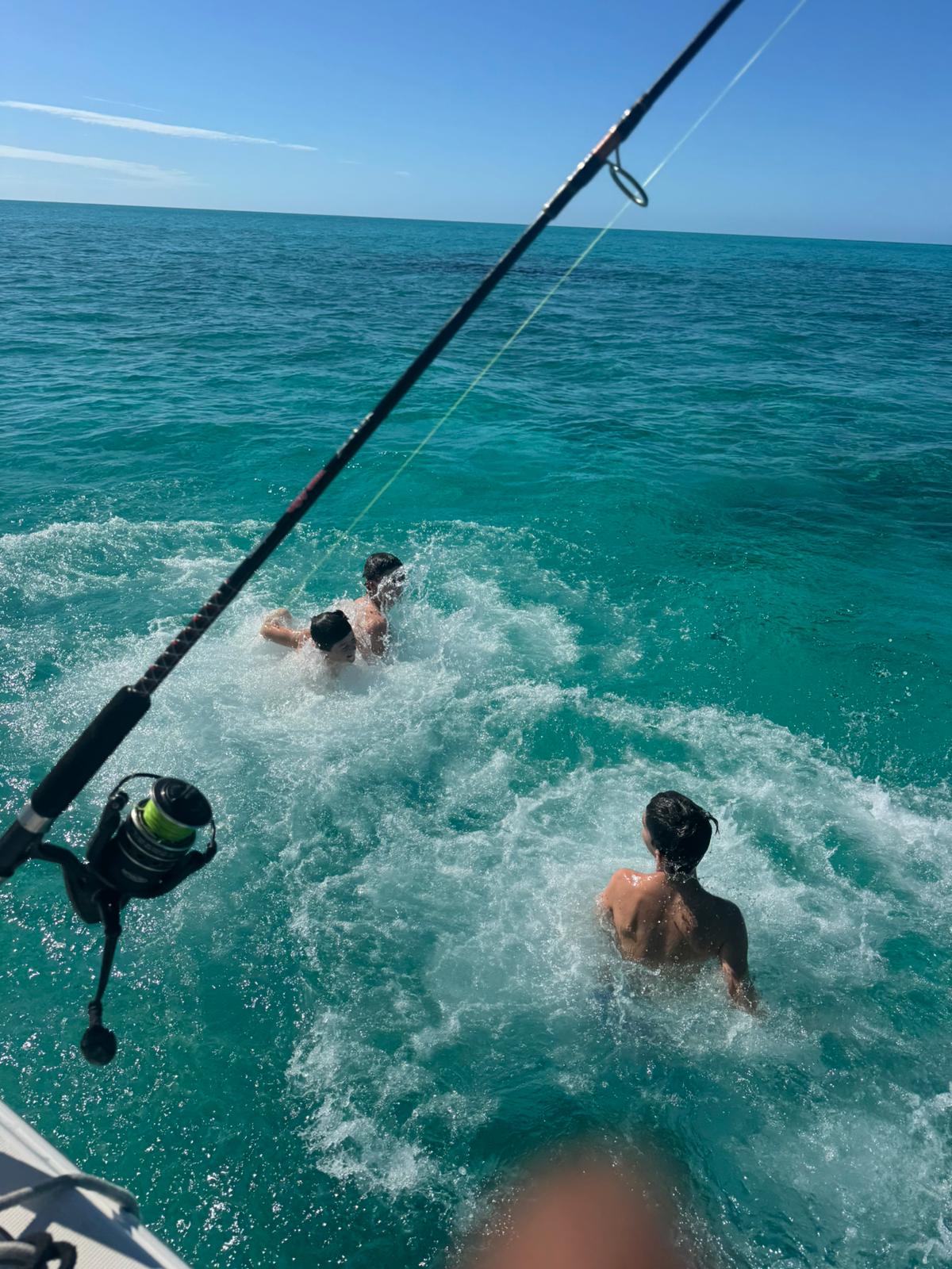 Guests swimming behind the boat